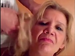 Blonde granny is taking a cumshot on her eyes 