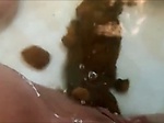 Woman shitting big turd in the water 